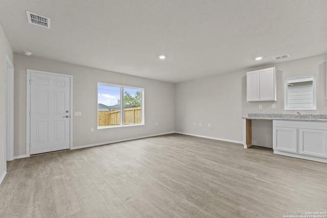 unfurnished living room with light wood-type flooring