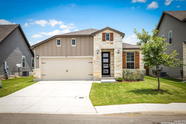 view of front of house with central AC unit, a front yard, and a garage