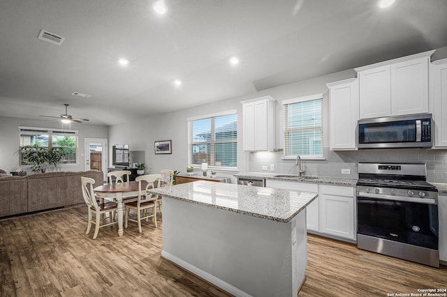 kitchen featuring white cabinets, light hardwood / wood-style floors, sink, and stainless steel appliances