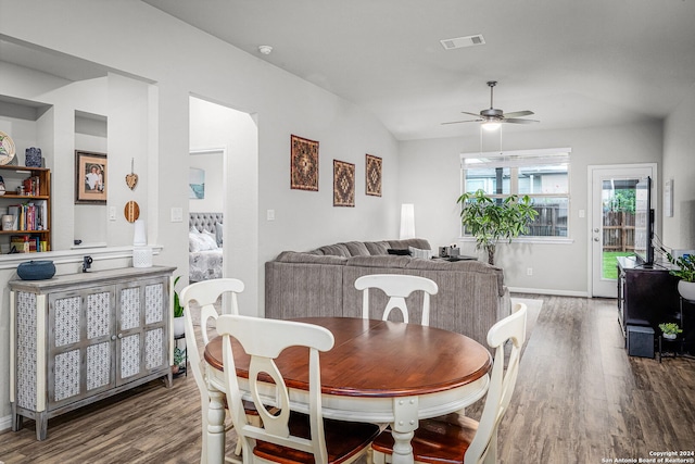 dining room featuring wood-type flooring, vaulted ceiling, and ceiling fan