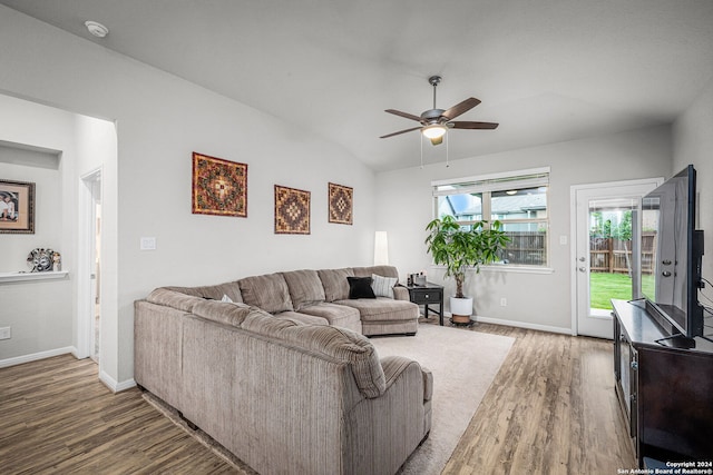 living room with ceiling fan, dark hardwood / wood-style flooring, and lofted ceiling