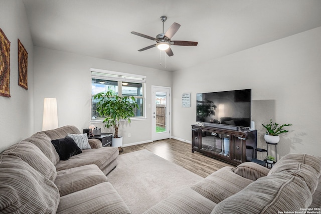 living room with ceiling fan and light hardwood / wood-style flooring