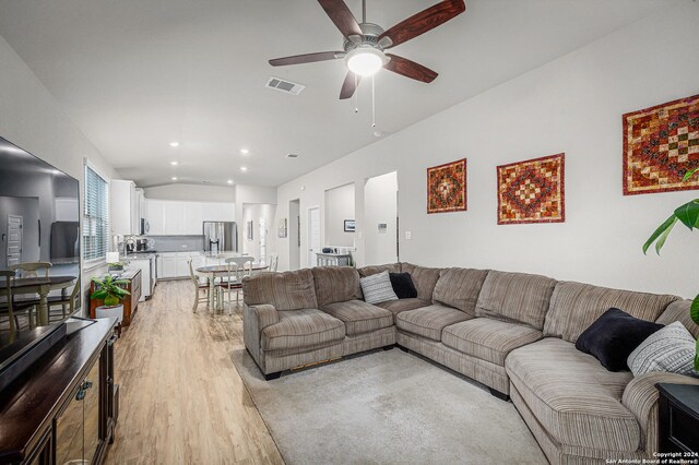 living room featuring ceiling fan and light wood-type flooring