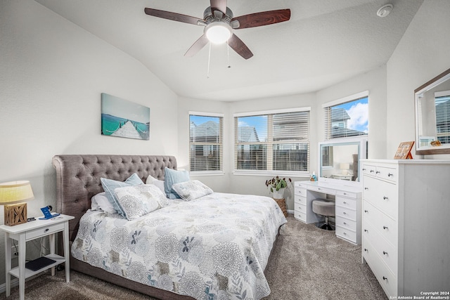 bedroom with dark carpet, ceiling fan, and lofted ceiling