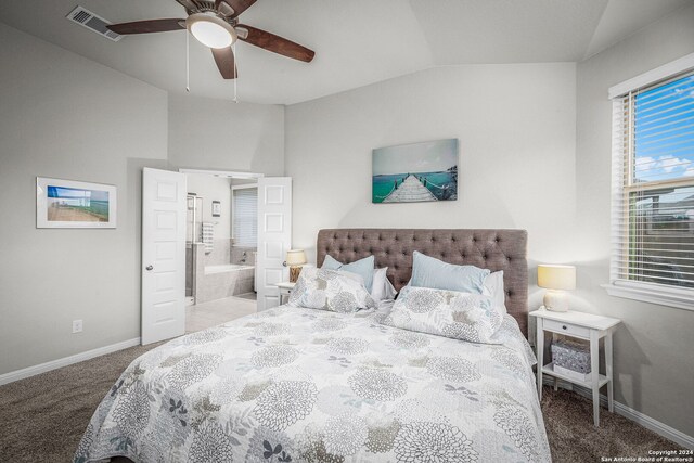 bedroom featuring carpet flooring, ensuite bath, vaulted ceiling, and ceiling fan