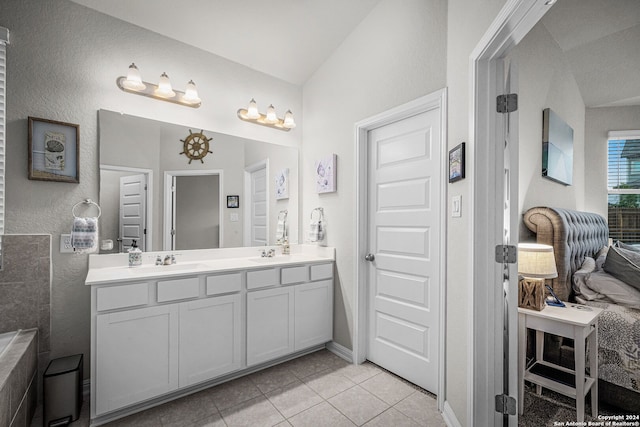 bathroom with tile patterned floors, vanity, and vaulted ceiling