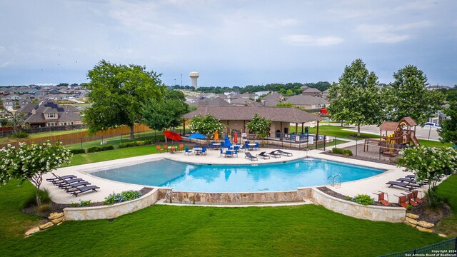 view of pool featuring a yard and a patio