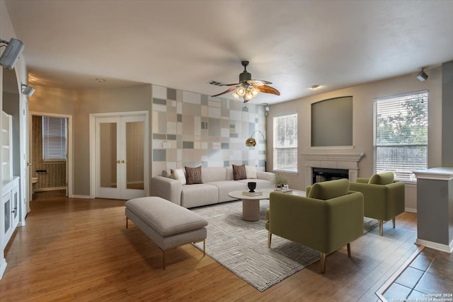 living room featuring hardwood / wood-style flooring, ceiling fan, and french doors