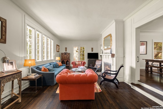 living room with dark wood-type flooring and ornamental molding