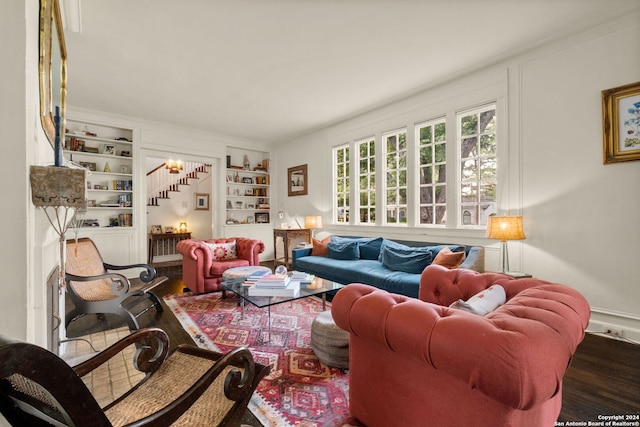 living room featuring hardwood / wood-style floors and built in shelves