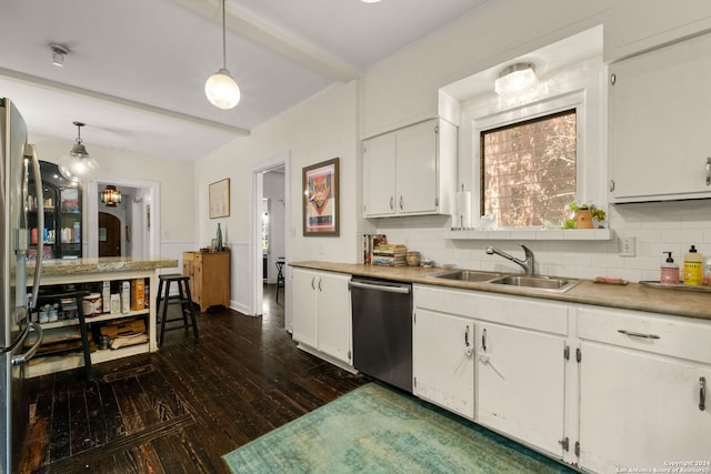 kitchen with appliances with stainless steel finishes, white cabinets, beam ceiling, pendant lighting, and sink