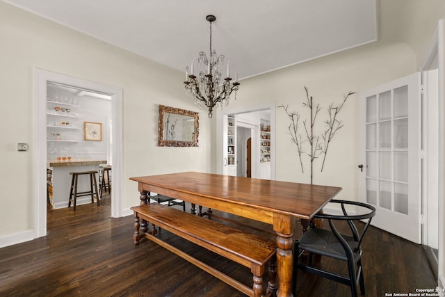 dining space with a chandelier and dark hardwood / wood-style floors