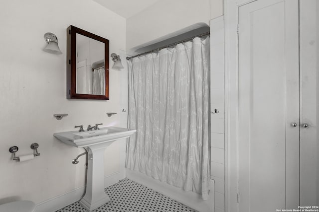 bathroom with tile flooring and toilet