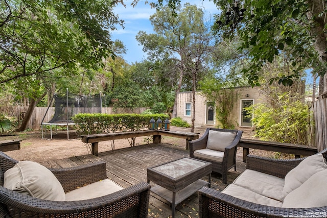 view of patio featuring a deck, a trampoline, and an outdoor hangout area