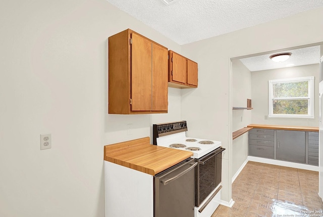 kitchen with dishwasher, a textured ceiling, and range with electric stovetop