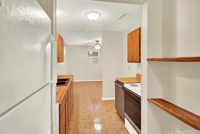 kitchen with a textured ceiling, white appliances, ceiling fan, and light tile patterned flooring