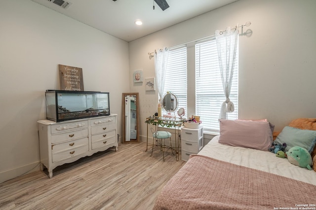 bedroom featuring multiple windows, ceiling fan, and light wood-type flooring