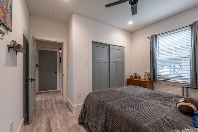 bedroom featuring a closet, light hardwood / wood-style flooring, and ceiling fan