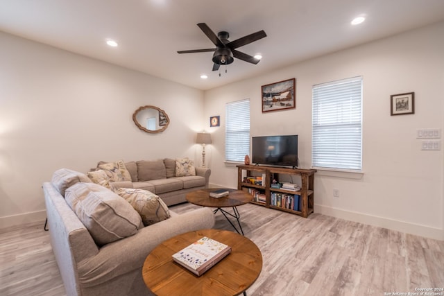 living room featuring light hardwood / wood-style floors and ceiling fan