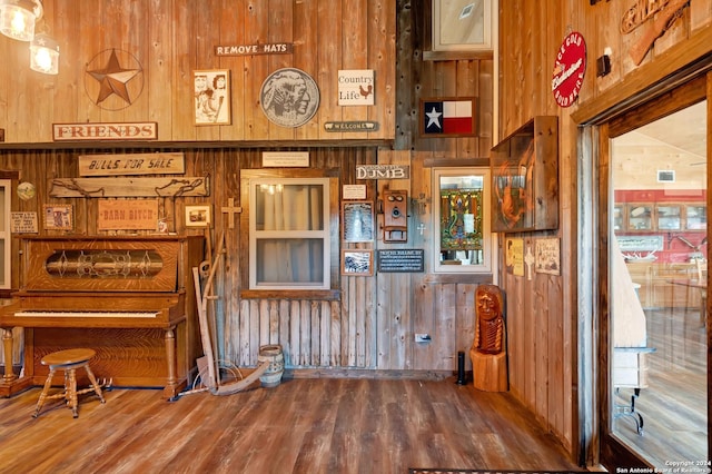 interior space with wooden walls and hardwood / wood-style floors