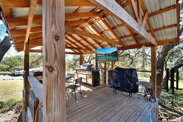 wooden terrace with a grill