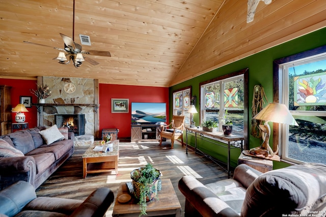 living room featuring lofted ceiling, a stone fireplace, plenty of natural light, and hardwood / wood-style flooring