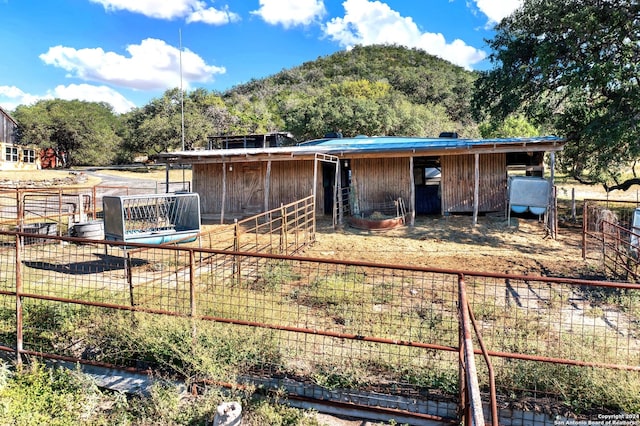 exterior space with an outdoor structure and a mountain view