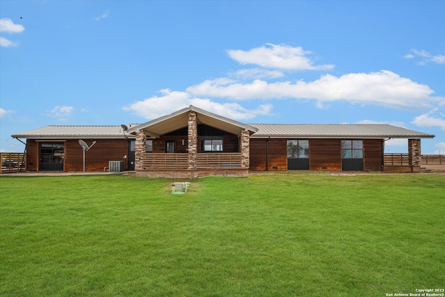 view of front of property with a front yard and central air condition unit