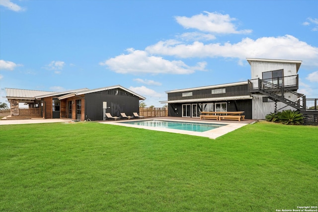 rear view of house featuring a yard