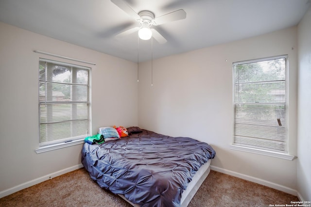 bedroom with ceiling fan and light colored carpet