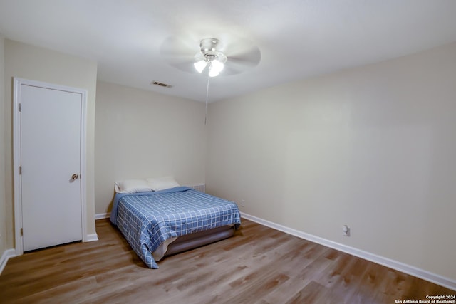 bedroom with ceiling fan and light hardwood / wood-style floors