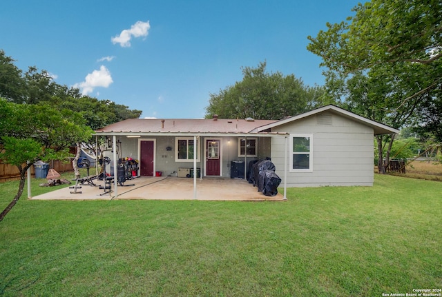 back of house featuring a patio and a lawn