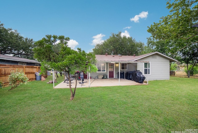 back of property featuring a patio area and a lawn