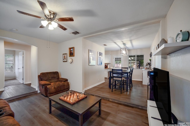 living room with wood-type flooring and ceiling fan