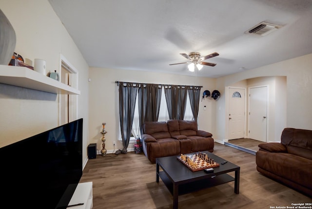 living room featuring wood-type flooring and ceiling fan