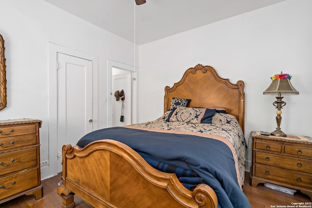 bedroom with ceiling fan and dark wood-type flooring