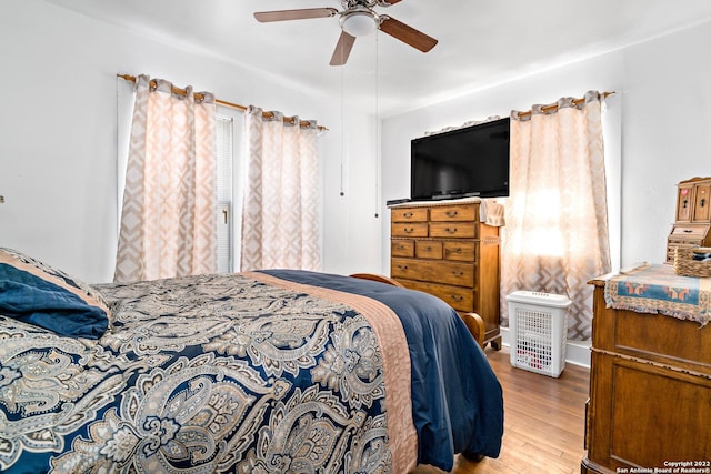 bedroom with ceiling fan and light hardwood / wood-style floors