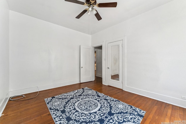 bedroom with ceiling fan and dark wood-type flooring