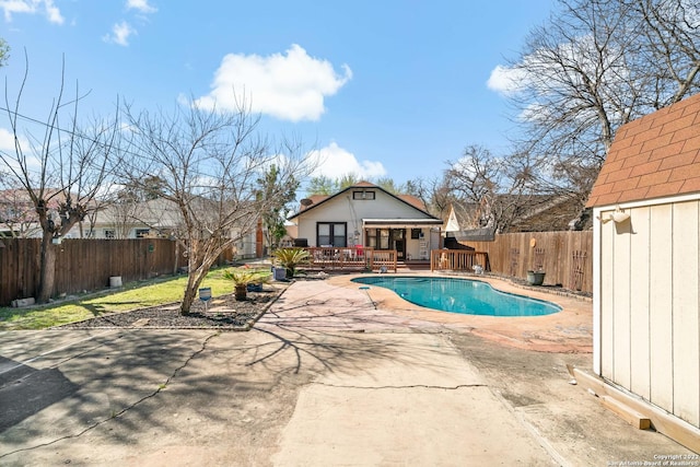 view of swimming pool with a patio and a wooden deck