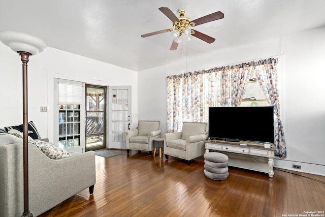 living room featuring dark hardwood / wood-style floors, ceiling fan, and a healthy amount of sunlight