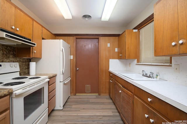 kitchen with tasteful backsplash, sink, light wood-type flooring, and white electric stove