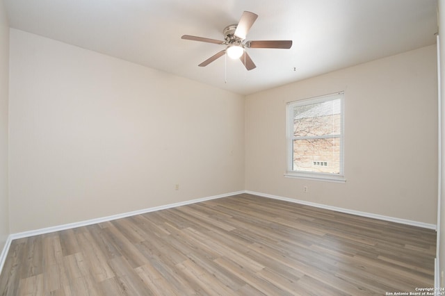 empty room featuring ceiling fan and light wood-type flooring