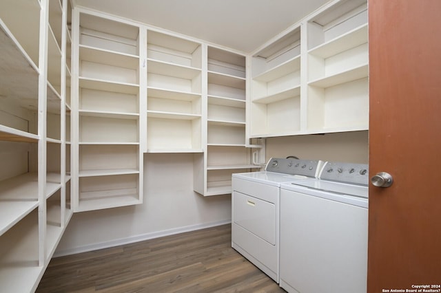 washroom with dark hardwood / wood-style flooring and washing machine and dryer