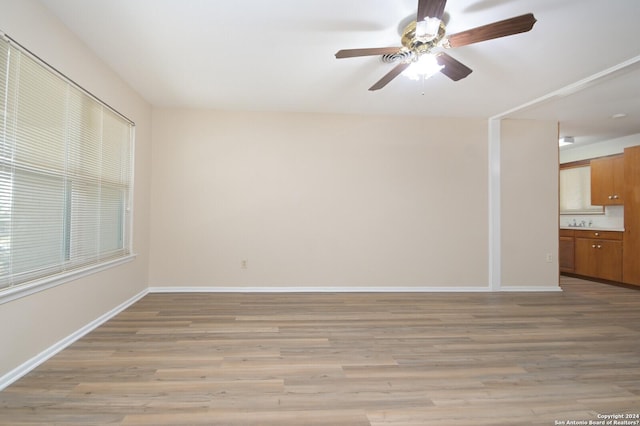 empty room featuring ceiling fan and light hardwood / wood-style floors