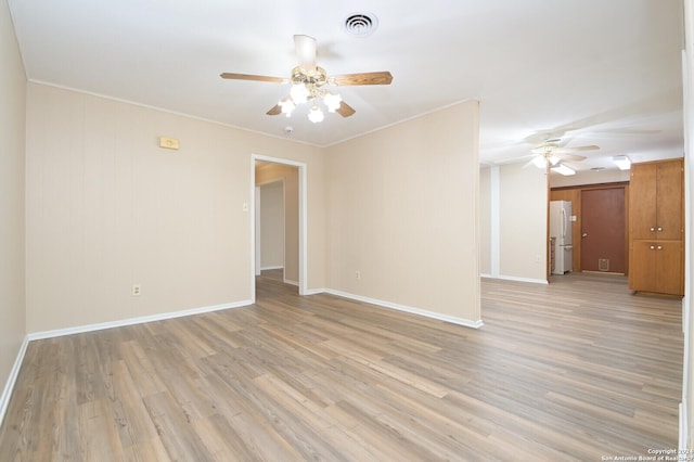 unfurnished room with light hardwood / wood-style floors and crown molding