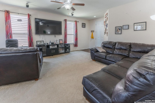 carpeted living room featuring ceiling fan and a healthy amount of sunlight