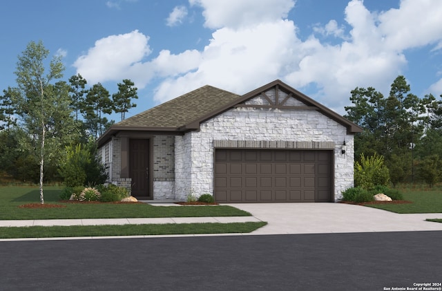 view of front of home with a front yard and a garage