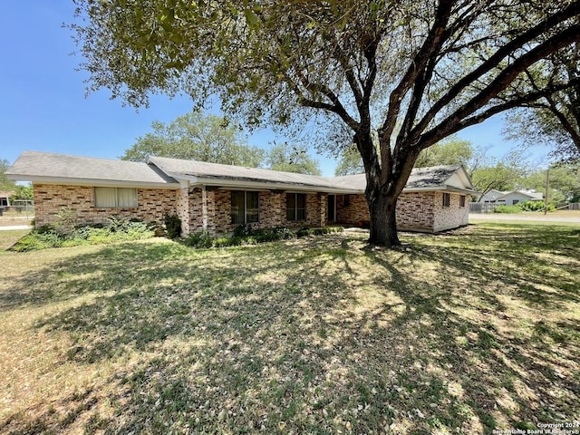 ranch-style home with a front lawn