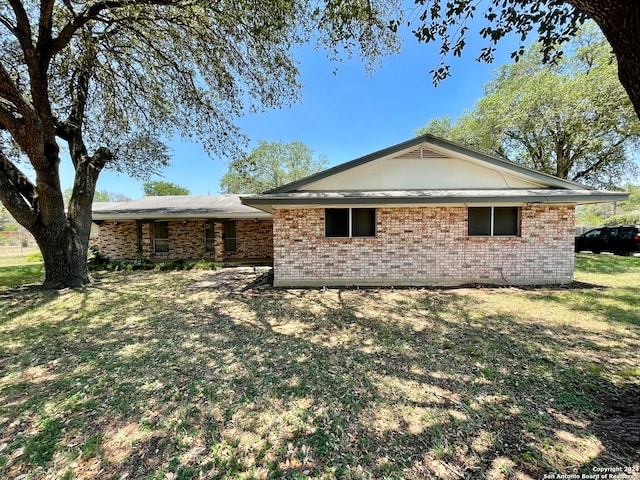 back of property featuring a patio area and a yard