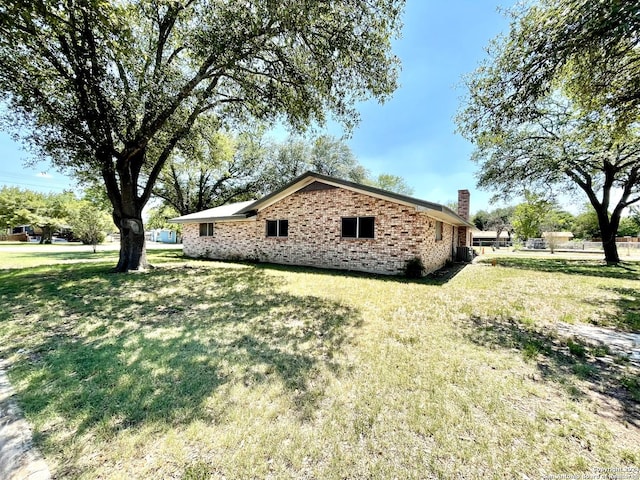 view of property exterior featuring a lawn